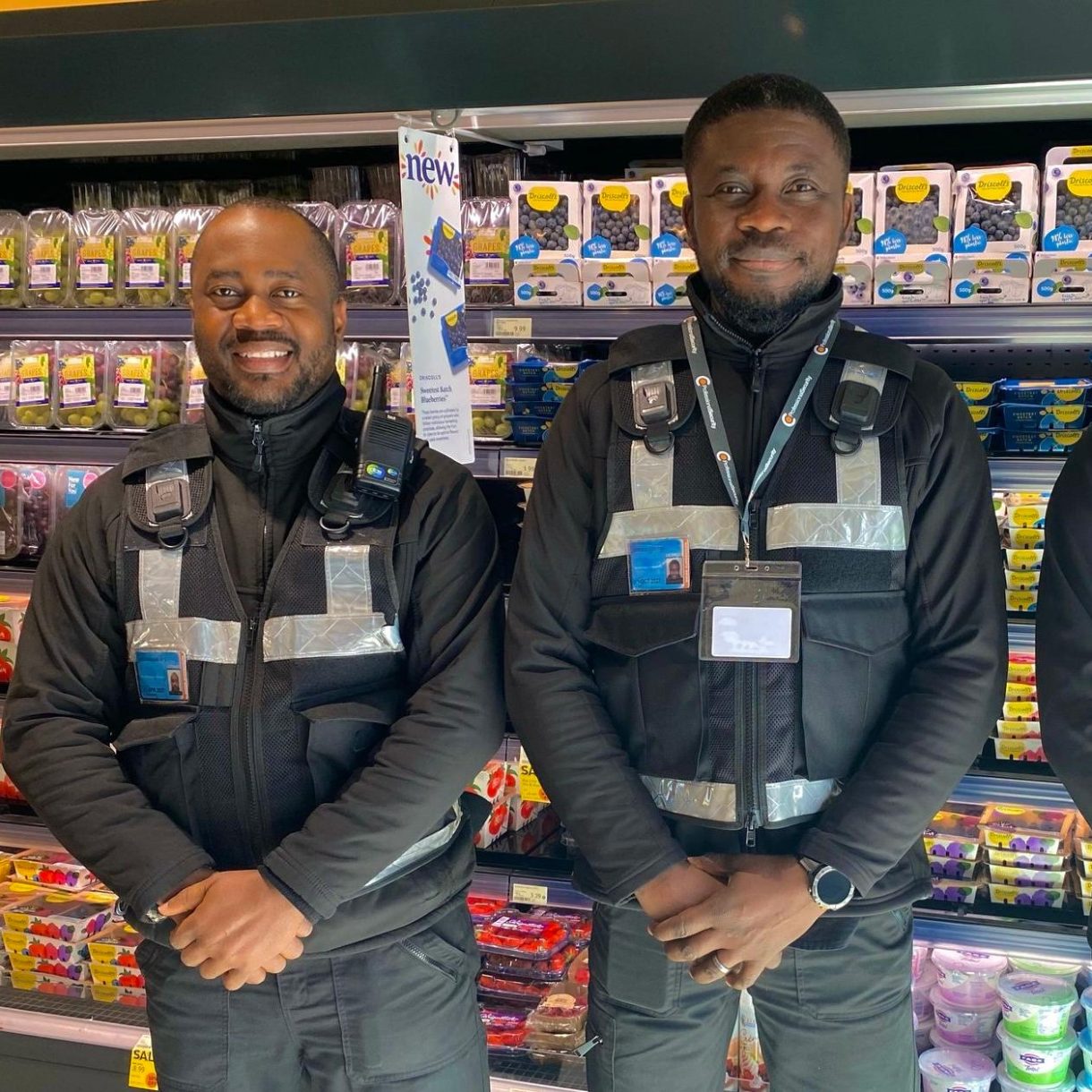2 retail supermarket security guards in front of stocked shelves