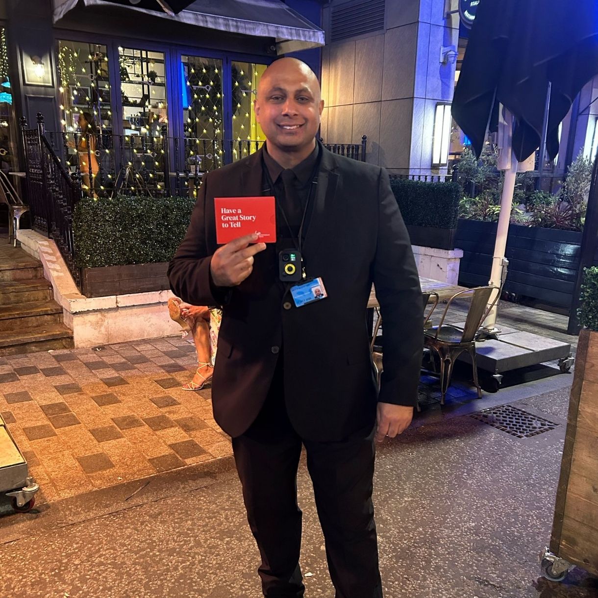 a man stood holding up a reward voucher